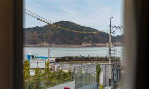 a view of a body of water from a balcony at Bluefrog Hotel in Incheon