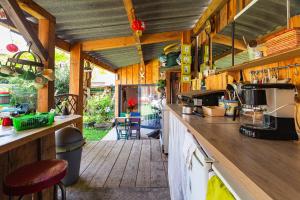 a kitchen with wooden walls and a wooden floor at Logement Bourbon - coeur Ardèche in Lamastre