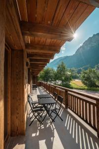 a balcony with tables and chairs on a building at CHALET LES CERFS in Châtel