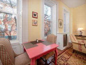 a dining room with a red table and chairs at La Reserve On Pine in Philadelphia