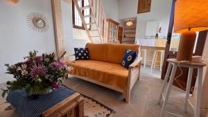 a living room with a couch and a kitchen at Casa Chula Estudio in Jimena de la Frontera