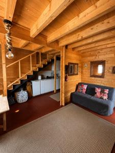 a living room with a couch in a wooden house at Casa rural 'La Huerta' in Rascafría