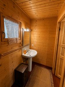 a bathroom with a sink in a wooden room at Casa rural 'La Huerta' in Rascafría +10 photos