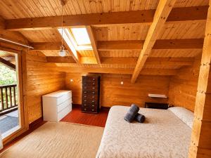 an attic room with a bed and a window at Casa rural 'La Huerta' in Rascafría