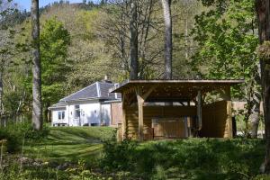 a house with a gazebo in a yard at Church Cottage in Inverness