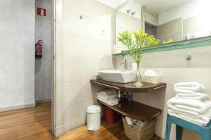 a bathroom with a sink and a mirror at Amseltim in Madrid +13 photos
