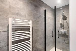 a bathroom with a shower and a glass door at Chalet nid des écureuils in Font-Romeu-Odeillo-Via +32 photos