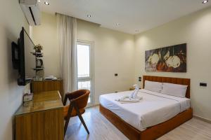 a bedroom with a bed and a desk with a swan on it at Elite Boutique Hotel in Cairo +67 photos
