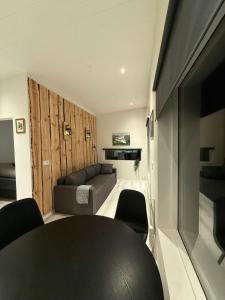 a living room with a couch and a table at Kirkjufell View Cottages in Grundarfjordur