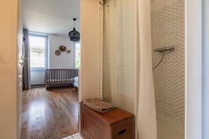 a bathroom with a shower and a wooden table at Gîte la Pigne in Aurel +29 photos