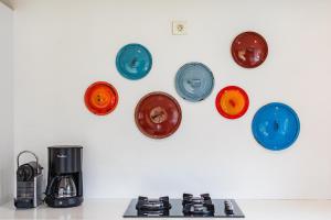 a group of plates on a wall above a stove at Gîte la Pigne in Aurel