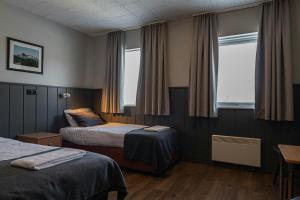 a hotel room with two beds and a window at Hotel Skaftafell in Skaftafell