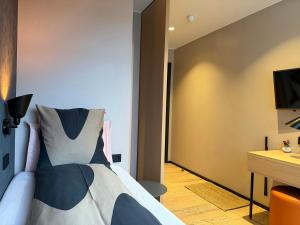 a bedroom with a bed and a desk and a television at Hotel Lotus in Reykjavík +82 photos