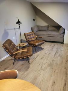 a living room with a couch and chairs and a table at Gistihúsið - Lake Hotel Egilsstadir in Egilsstaðir +102 photos