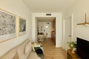 a living room with a couch and a tv at Be Casa Sant Cugat in Sant Cugat del Vallès