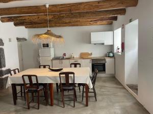 a kitchen and dining room with a table and chairs at Casa Baía da Lagoa in Lagoa