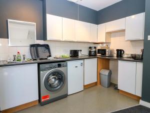 a kitchen with a washing machine and a washer at Apartment 2 in Aberdeen +17 photos