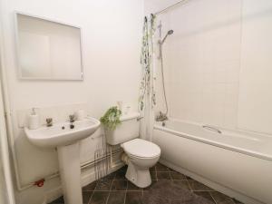 a bathroom with a sink and a toilet and a bath tub at Apartment 2 in Aberdeen