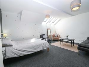 a bedroom with a bed and a chair and a table at Apartment 2 in Aberdeen