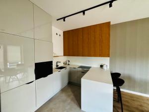 a kitchen with white cabinets and a counter at Słoneczny Taras in Kęty