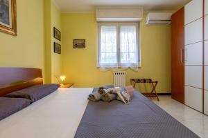 a bedroom with a bed with a doll laying on the floor at Cuncordu Affittacamere- Sassari in Sassari