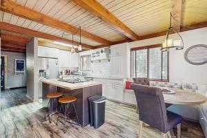 a kitchen with white cabinets and a table and chairs at The Music Chalet in Ronald