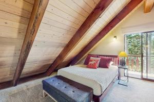 a bedroom with a bed and a wooden ceiling at The Music Chalet in Ronald