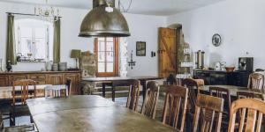 a kitchen and dining room with wooden tables and chairs at Dom Sokolik in Trzcińsko +58 photos