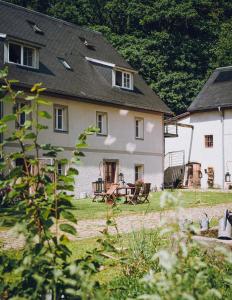 a large white house with a table in the yard at Dom Sokolik in Trzcińsko
