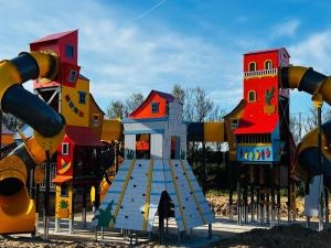 a playground with colorful play structures on it at Détente en 4 étoiles jusque 6 personnes, selon la dispo in Saint-Jean-de-Monts