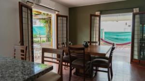 a dining room with a wooden table and chairs at El descanso - Costa Azul in Villa Carlos Paz