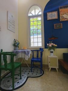 a room with two chairs and a table and a window at Green hill side Villa in Cồn Giả Viên