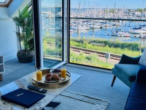 a living room with a view of a harbor at Island Point Horizon View in Lymington