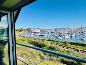 a view of a marina from a train window at Island Point Horizon View in Lymington