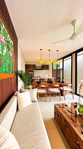 a living room with a couch and a table at 3BR Nava villa Ubud in Ubud