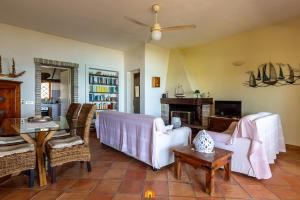 a living room with a couch and a table at Villa Teresa Simius Beach Front in Simius