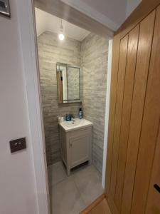 a bathroom with a sink and a mirror at Windsor Flat 90A in Windsor