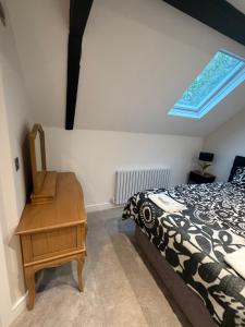 a bedroom with a bed and a desk and a window at Windsor Flat 90A in Windsor