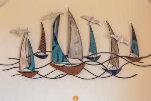 a group of sailboats hanging on a wall at Villa Teresa Simius Beach Front in Simius
