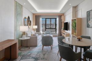 a living room with a table and chairs at Makarem Haram view suites in Medina