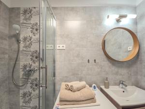 a bathroom with a shower and a sink and a mirror at Trend Apartman in Bük +41 photos