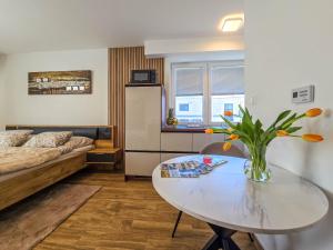 a small room with a table and a bed at Trend Apartman in Bük