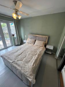 a large bed in a bedroom with green walls at Spacious King En Suite in St. Albans