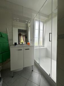 a white bathroom with a shower and a sink at Chambres d'Hôtes Le Clos Tassin in Colleville-sur-Mer +38 photos