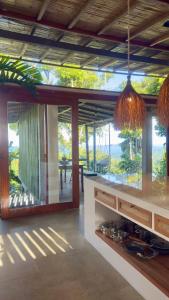 a kitchen with a large glass window with a view at Wild Wasi - Private Jungle Villa in Puyo