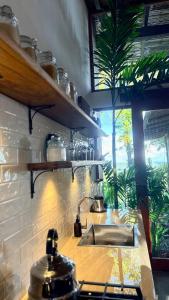 a kitchen with a sink and a window at Wild Wasi - Private Jungle Villa in Puyo