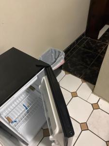 a small refrigerator with its door open in a kitchen at Joe's Studio in San Juan