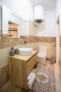 a bathroom with a sink and a toilet at Hogar de la plata in Sanlúcar de Barrameda +19 photos