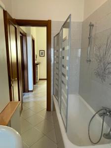 a bathroom with a bath tub and a sink at Casa dell'OCA in Viganò