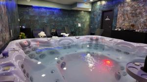 a jacuzzi tub in a room with a table at Airfield Hotel & Spa in Vibo Valentia